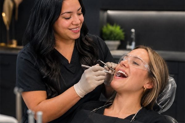 An Old Oaks Dental clinician treating a patient in the dental chair